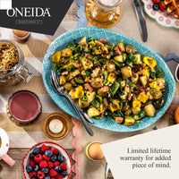 Oneida table setting with a dish of food, berries, and drinks on a wooden table.