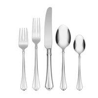 Set of silver cutlery including two forks, a knife, and two spoons on a white background.